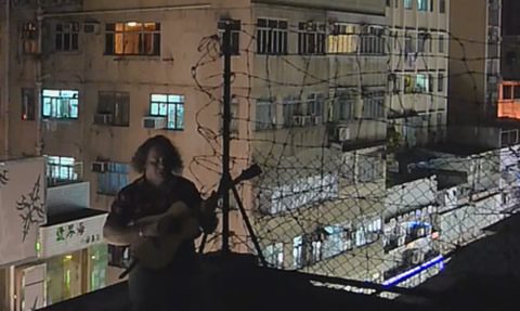 Playing 'Lakes of Pontchartrain' - on a tenement roof in Hong Kong